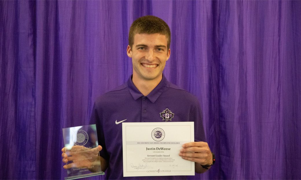 A man smiling at the camera with a certificate.