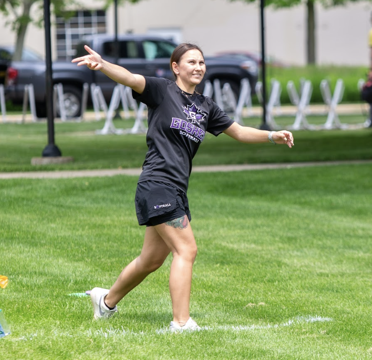 Goshen college student running with open arms