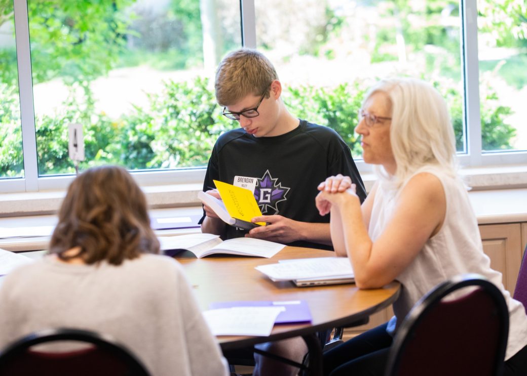 Goshen college students talking in a table