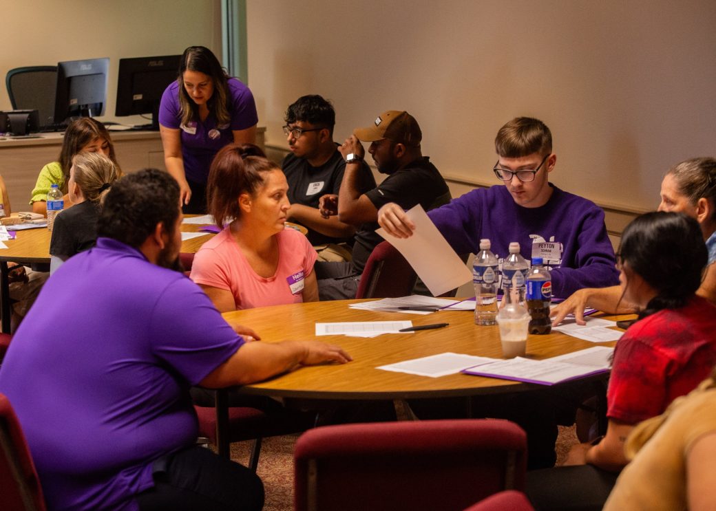 Goshen college students at the table with papers