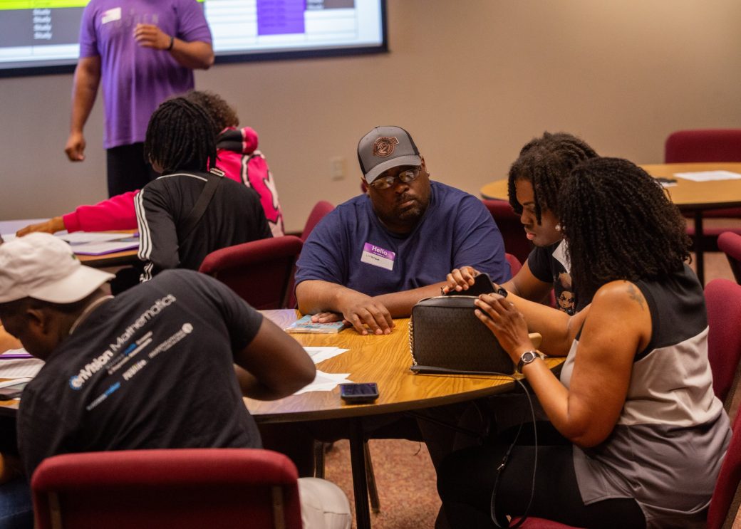Goshen college students at the table with papers talking