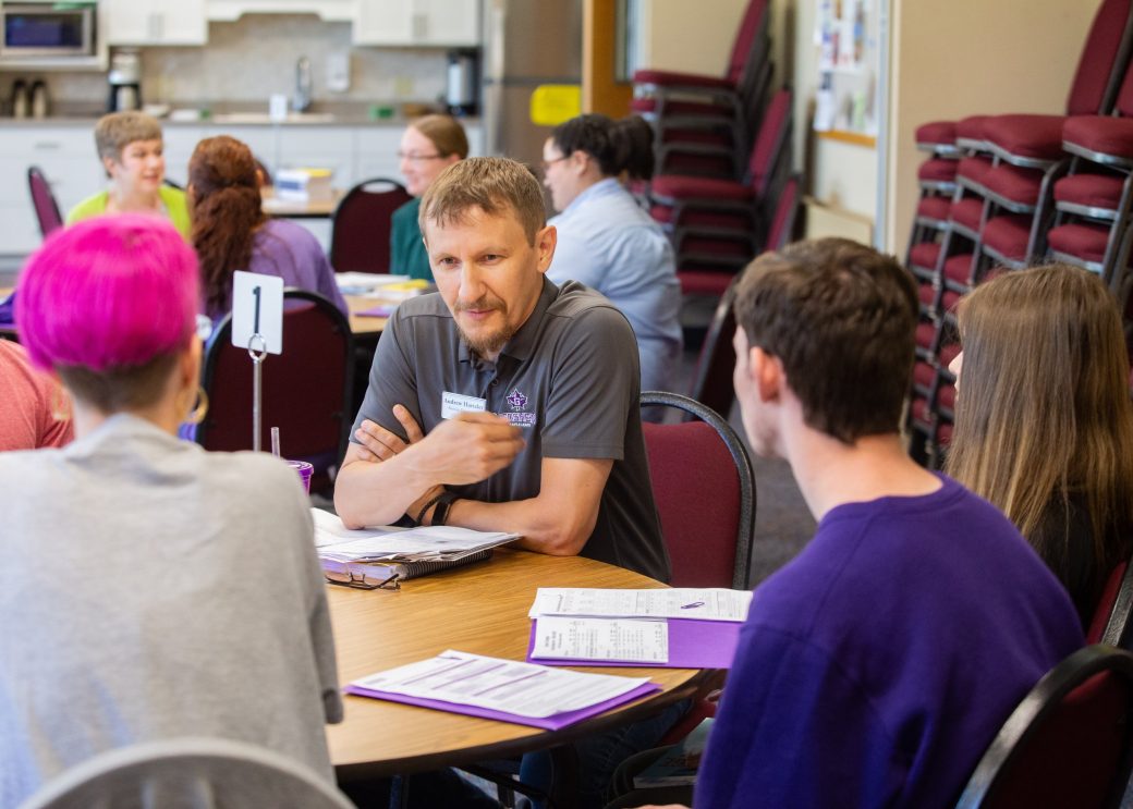 Goshen college students talking in a table