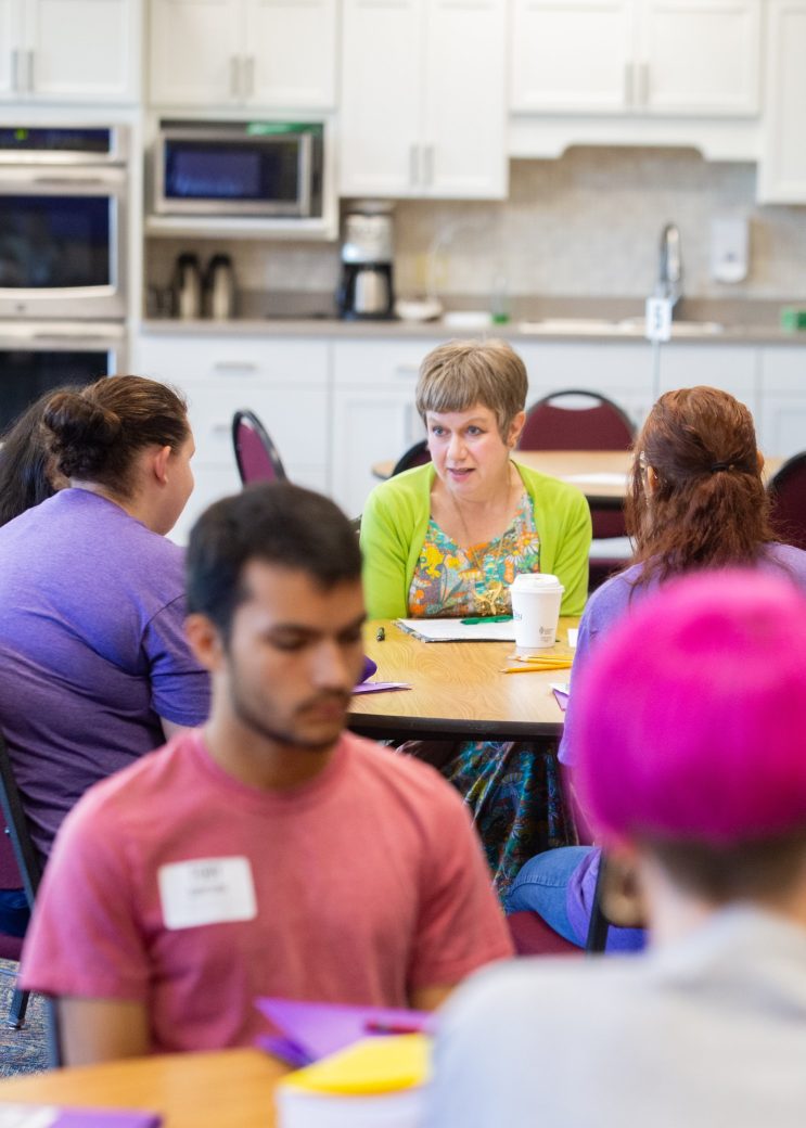 Goshen college students talking seated