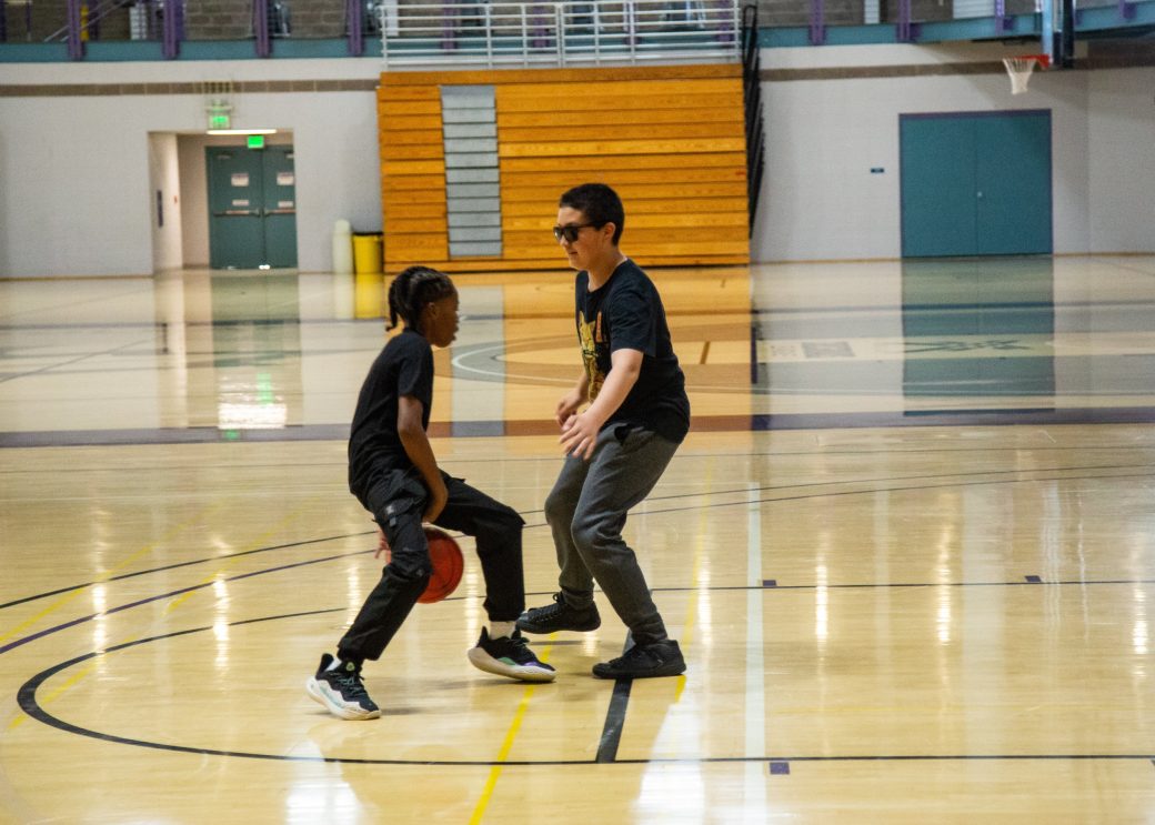 Teens playing Basketball in a gym