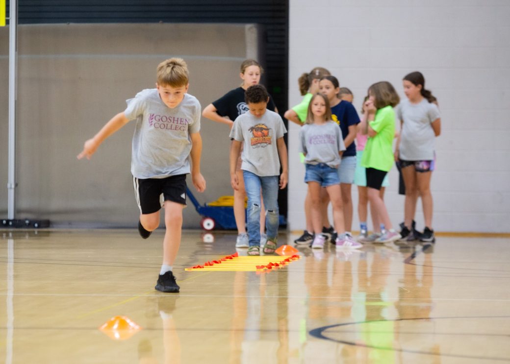 Kid playing in a gym at Summer Camps 2024