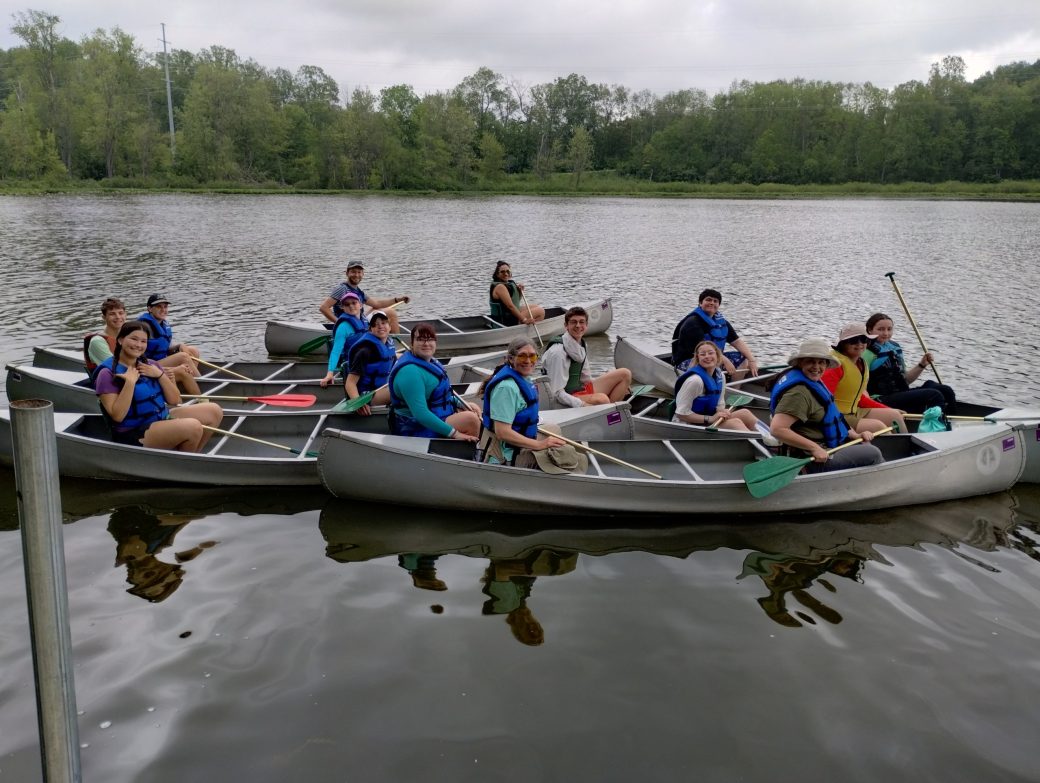 People traveling by boat at Summer Camps 2024
