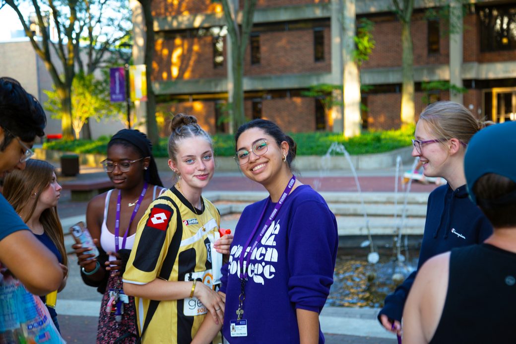 Goshen college students smiling to the camera at start of classes