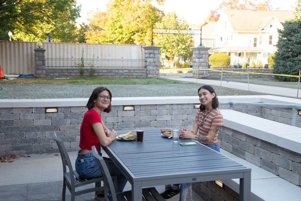 Two goshen college students smiling to the camera at Westlawn Dining Hall