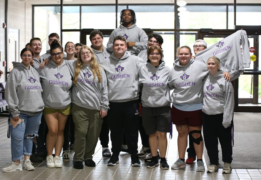 GC students- athletes hugging and smiling to the camera