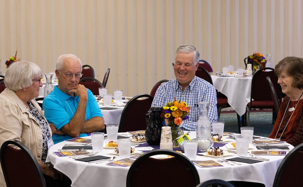 Two men having a dinner and talking at a table
