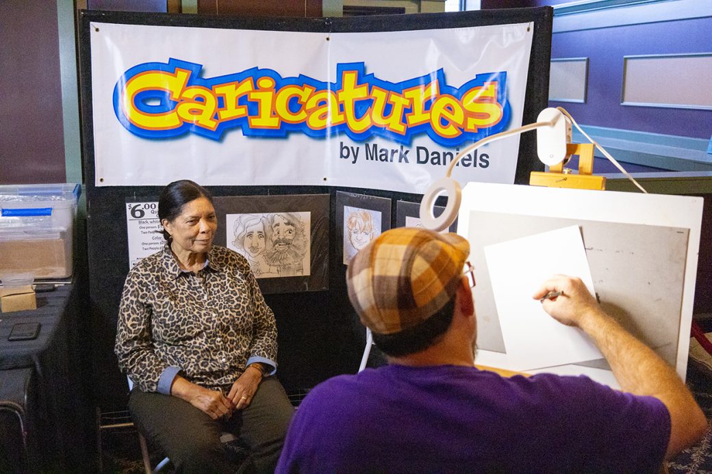 Artist doing an art of a woman at Connectapalooza