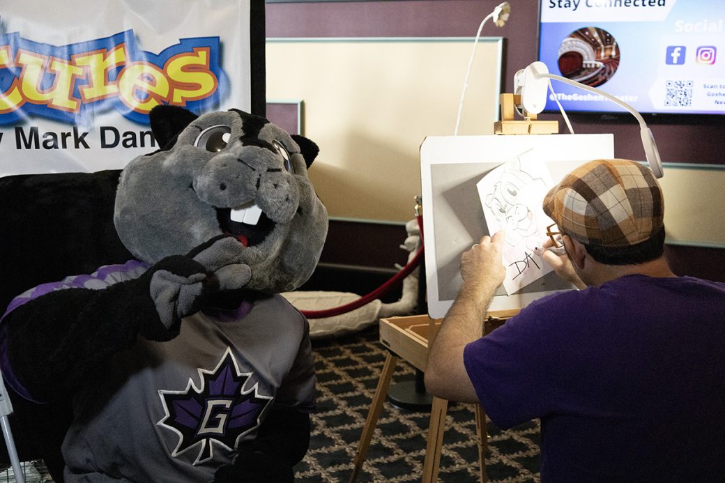 Artist doing an art of Dash at Goshen college