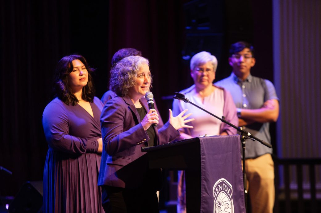 People giving a speeach at the stage's podium