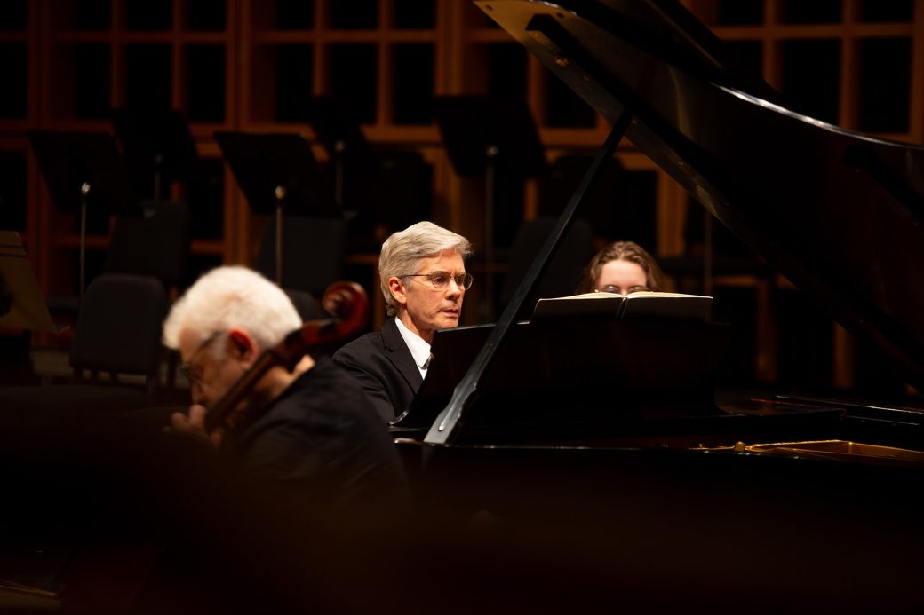 man in suit playing piano at Homecoming Weekend 2024