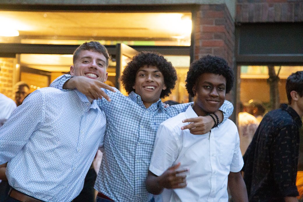 Three young boys hugging at Goshen college
