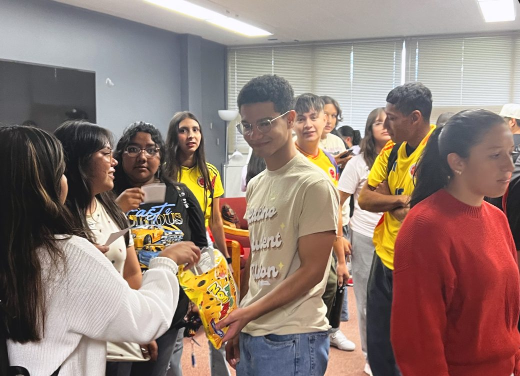 Student offering snacks to other GC students