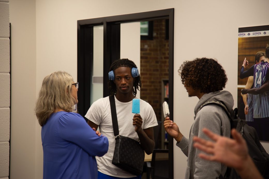 Students talking with their teacher