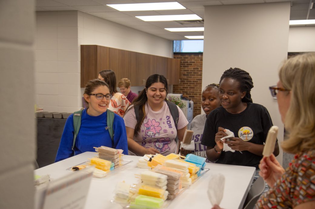 Goshen college students tasting popsicle