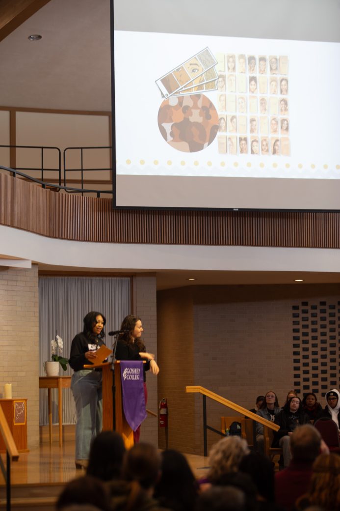 Goshen college students giving a a speech in the chapel