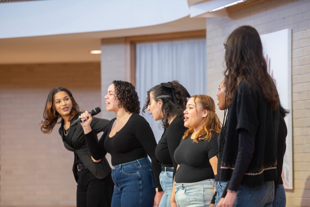 Goshen college students one of them is doing a speech in chapel's stage at MLK Celebration 2025