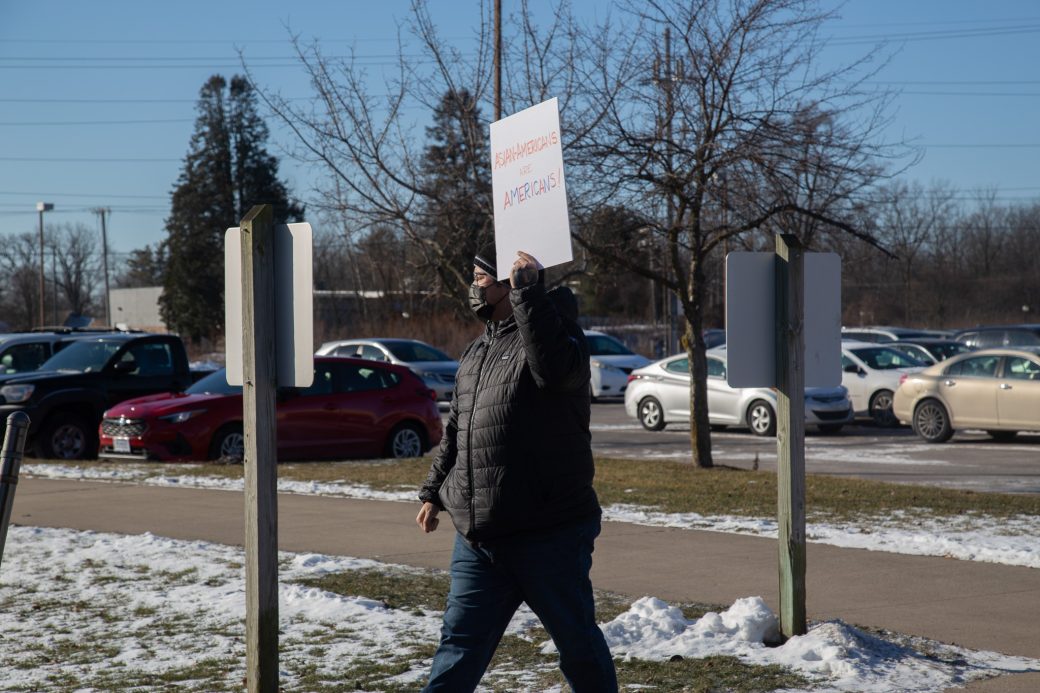 Man marching to the Rec-Fit center with a plaque at MLK Celebration