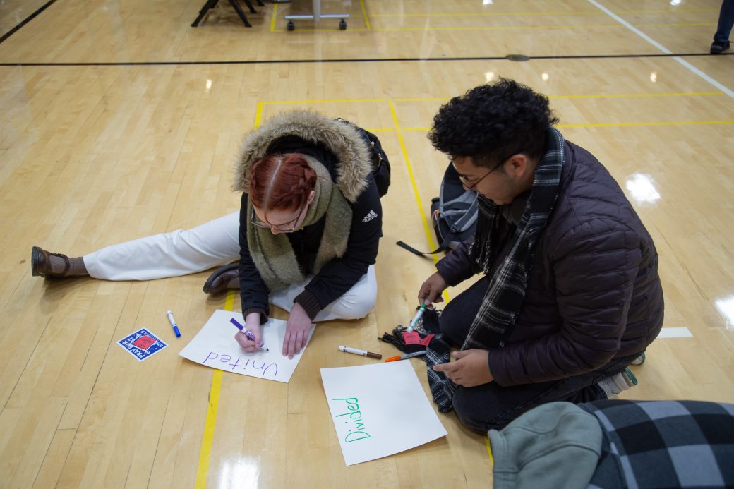 Student decorantig papers at MLK Celebration day