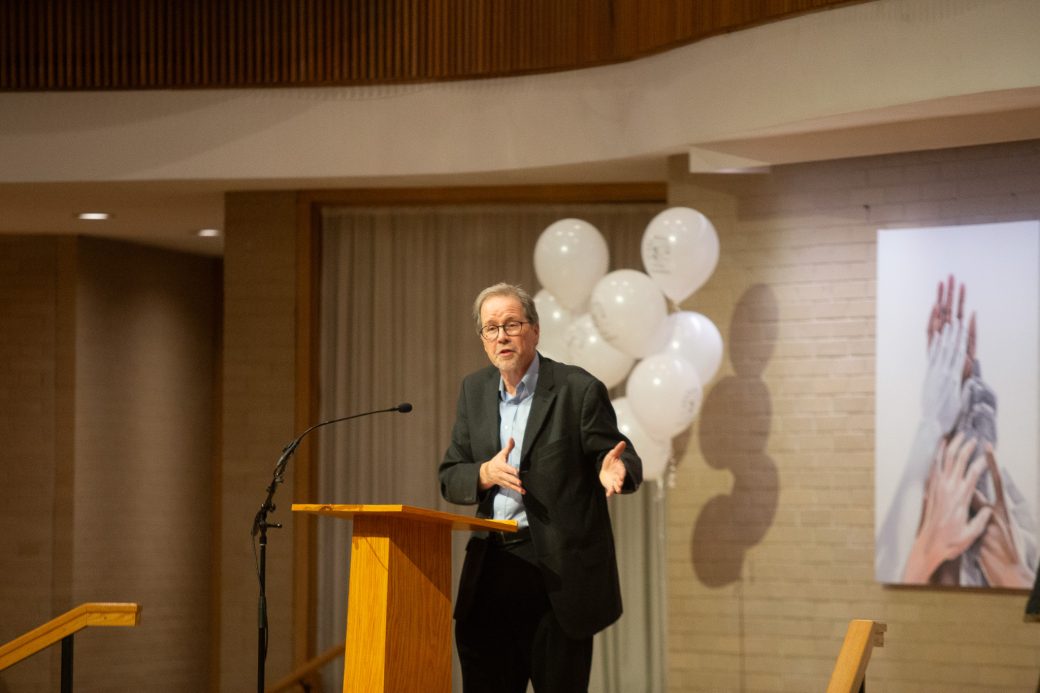 man doing a speech at stage's pulpit
