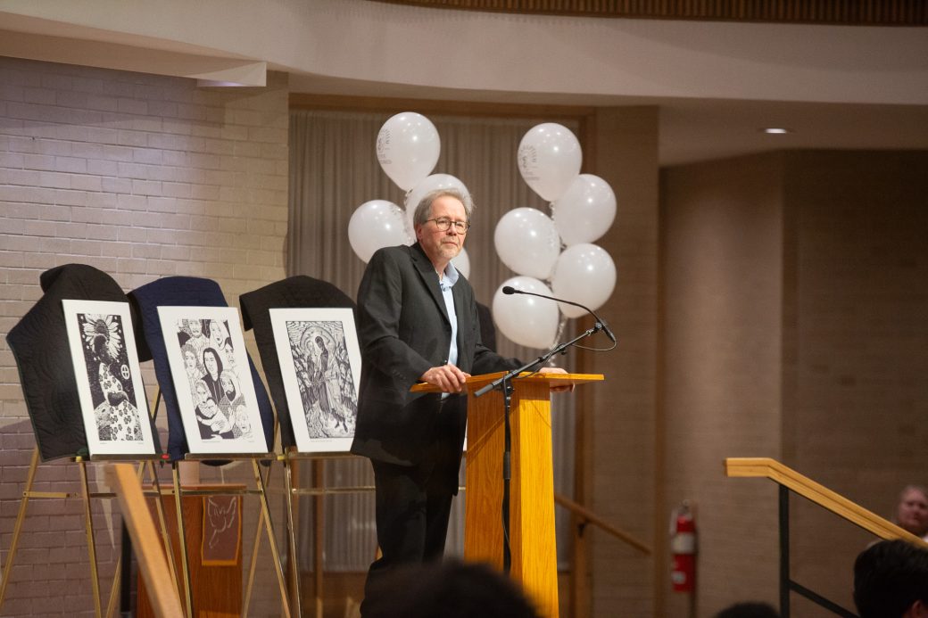 man doing a speech at stage's pulpit
