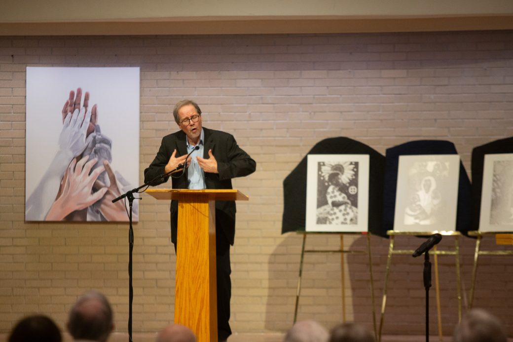 man doing a speech at stage's pulpit