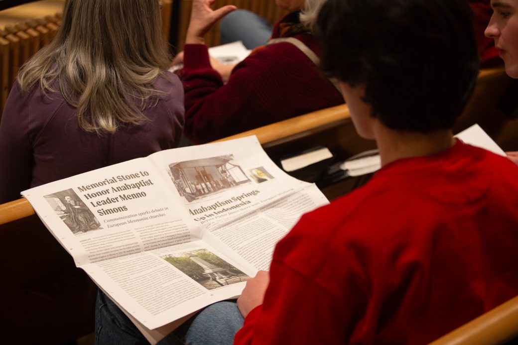 Man reading a paper about Anabaptism