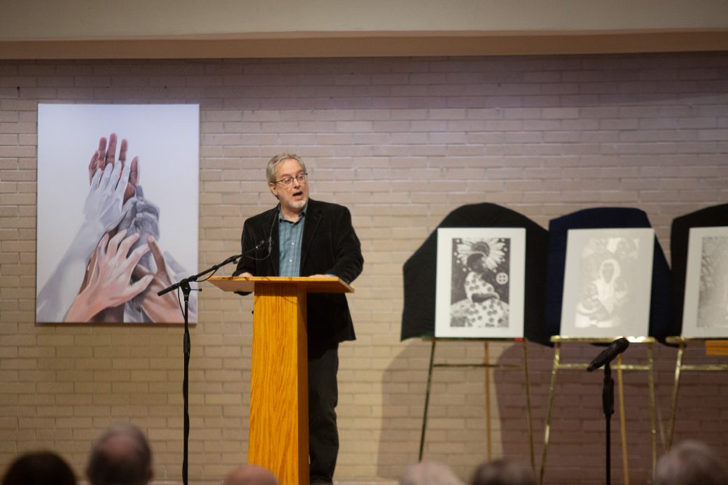 man doing a speech at stage's pulpit