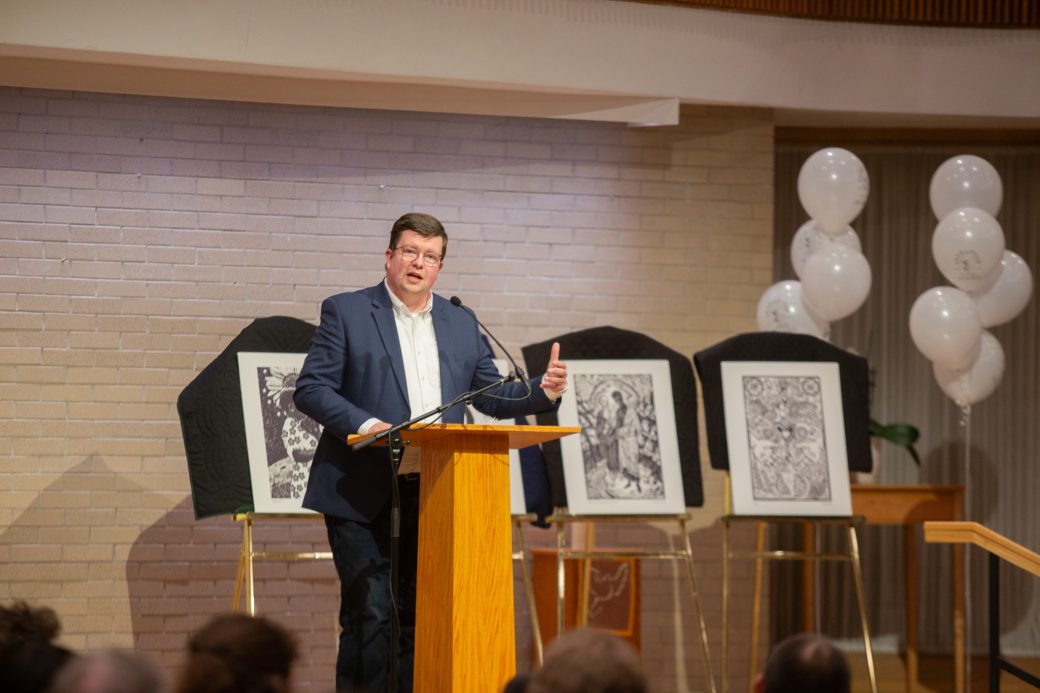 man doing a speech at stage's pulpit