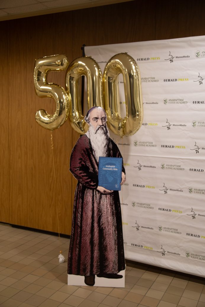 George Blaurock figure holding a book in Anabaptism Ceremony