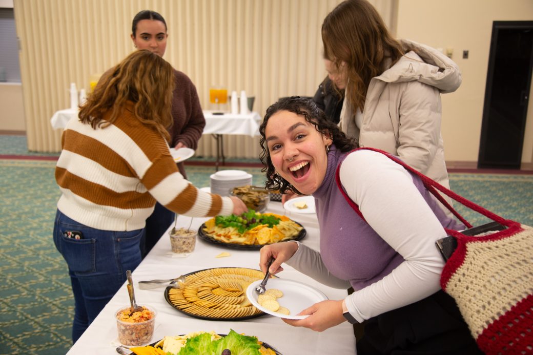 People serving themselves with foodof the table at Anabaptism Celebration