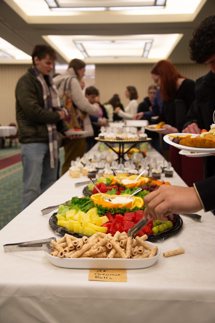 People serving themselves with food of the table at Anabaptism Celebration