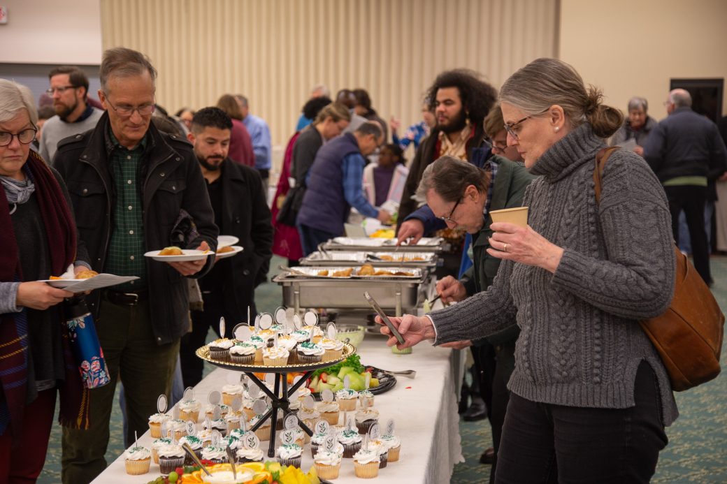 People serving themselves with food