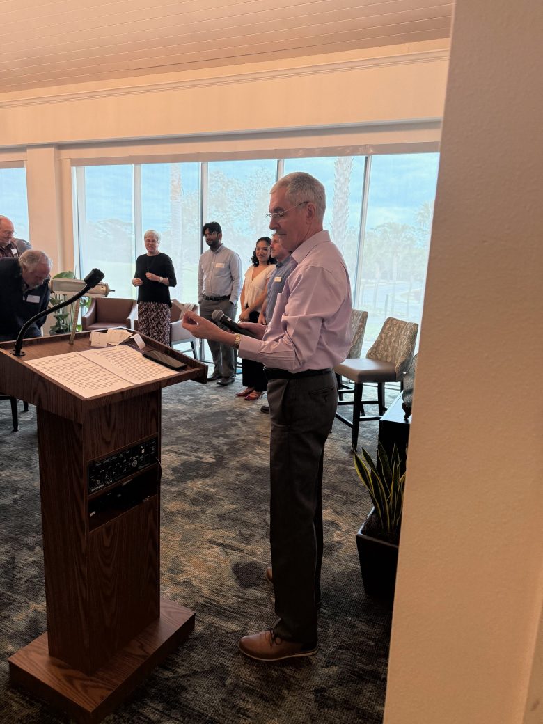Man speaking in a pulpit at Connected Cause Alumni & Friends Gathering: Sarasota, Florida