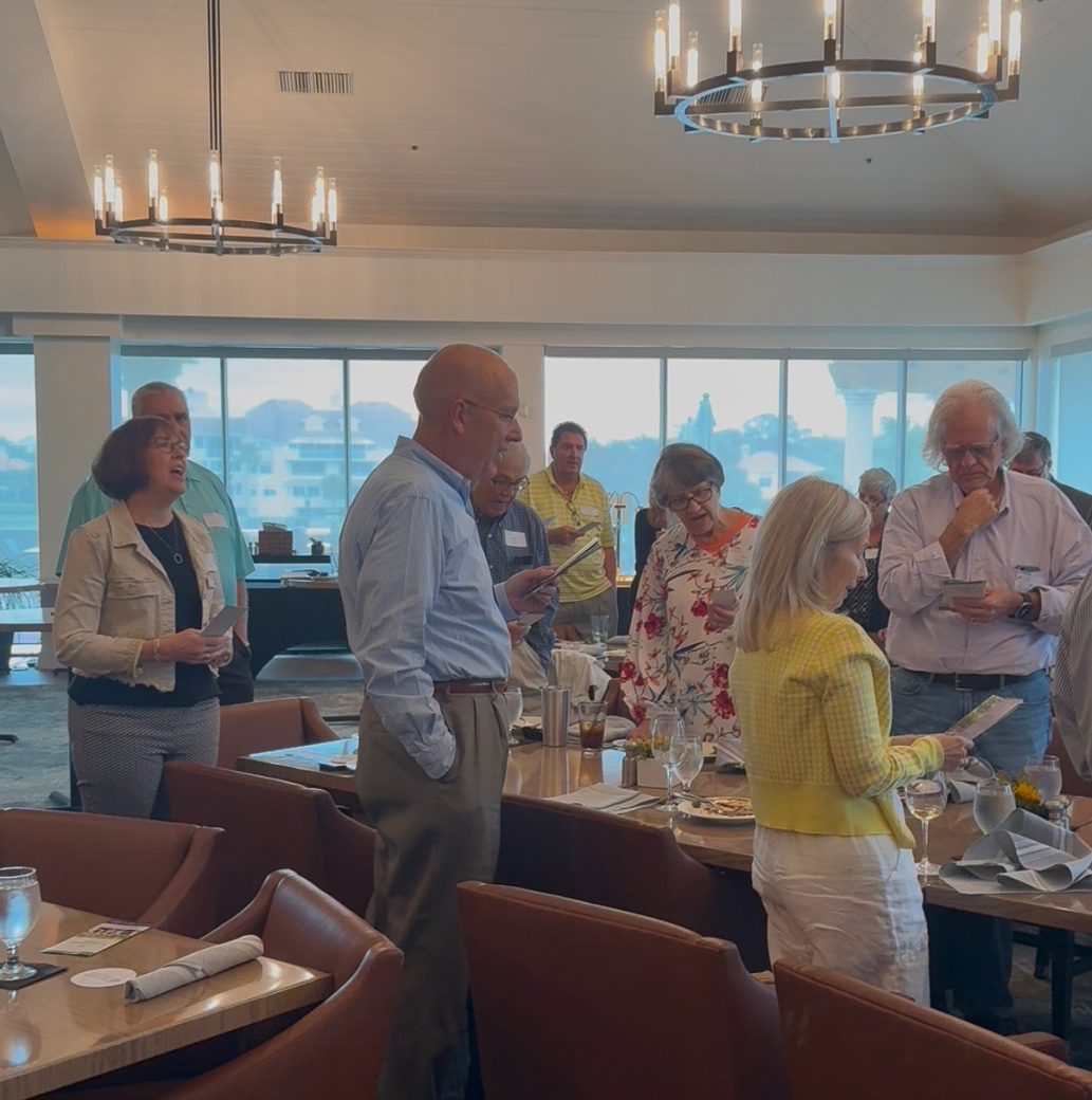 People standed up at Connected Cause Alumni & Friends Gathering: Sarasota, Florida