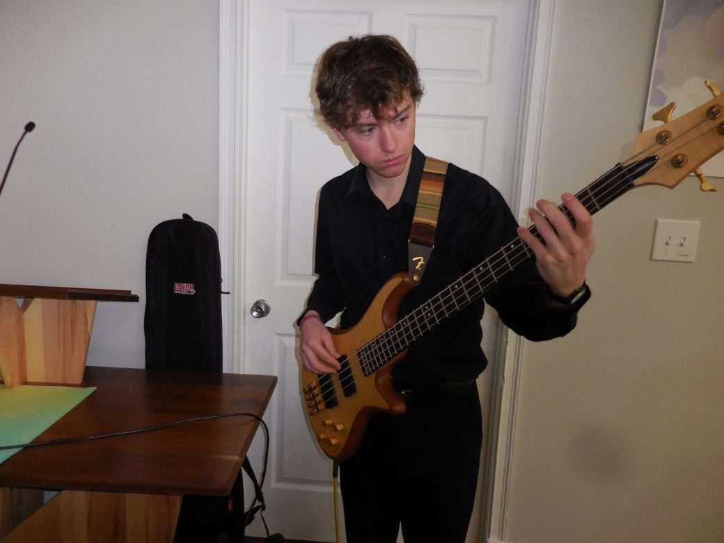 Boy playing an eletronic guitar