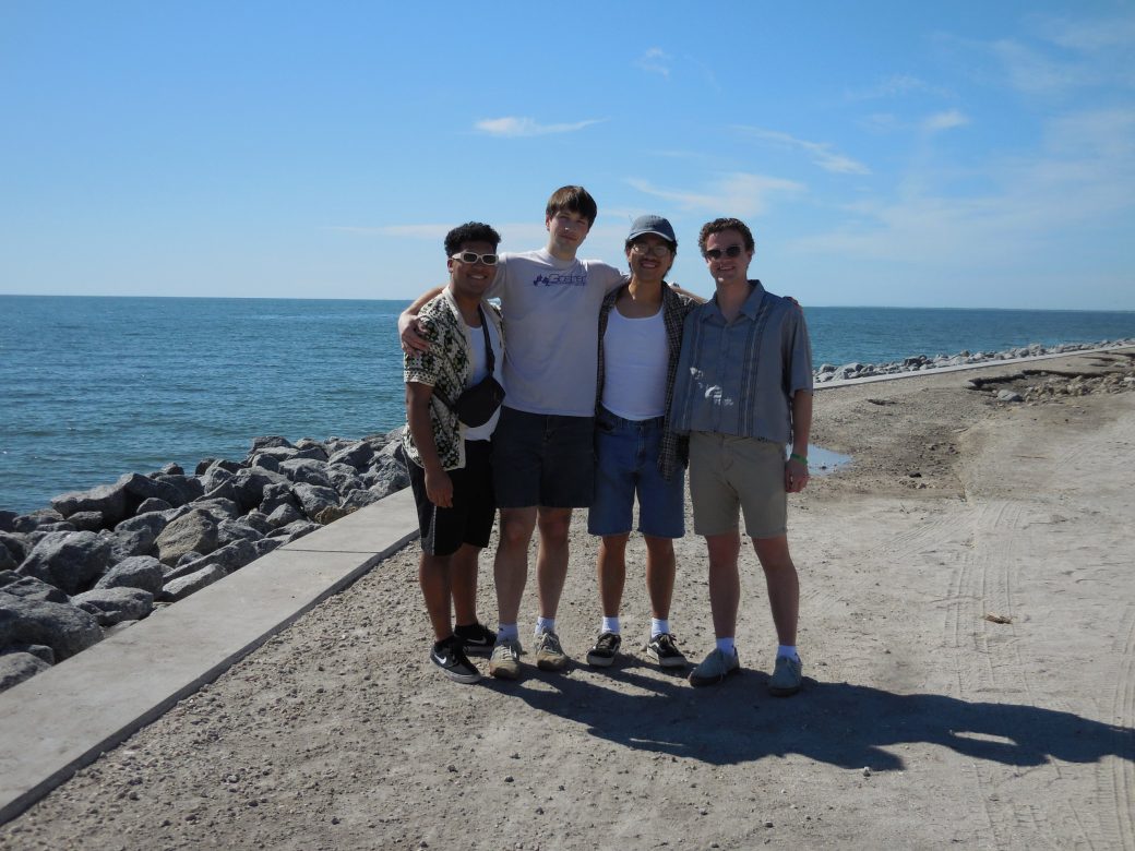 Four men smiling to the camera