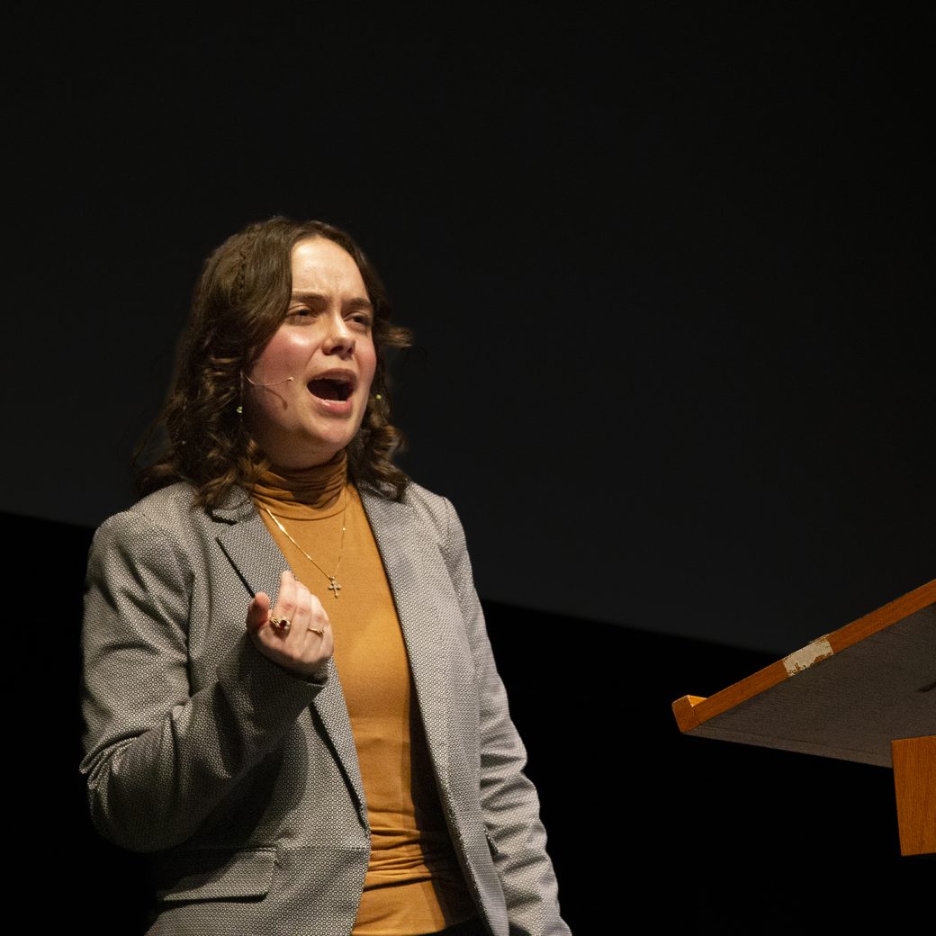 A student speaks passionately at a podium