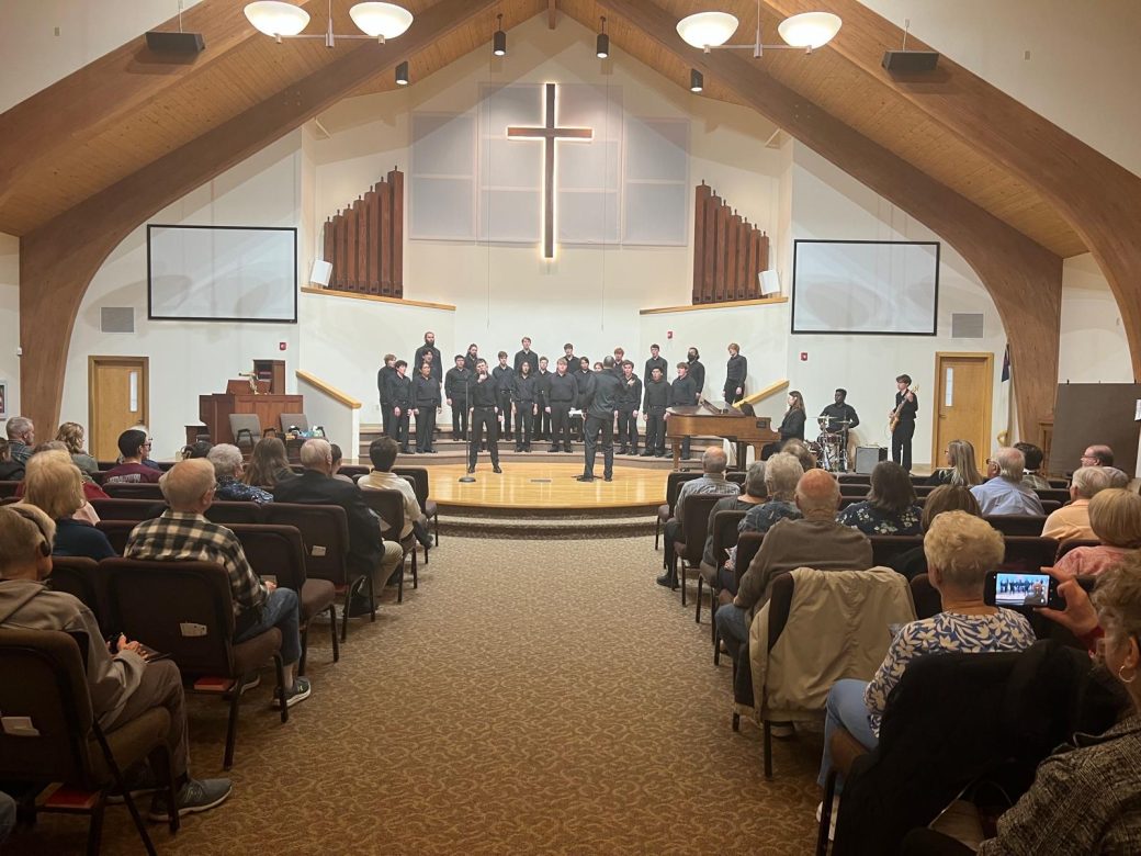 Goshen's college students music choir singing in a church