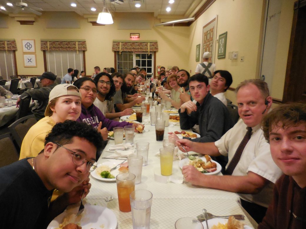 Teachers and students of the Goshen college having a dinner