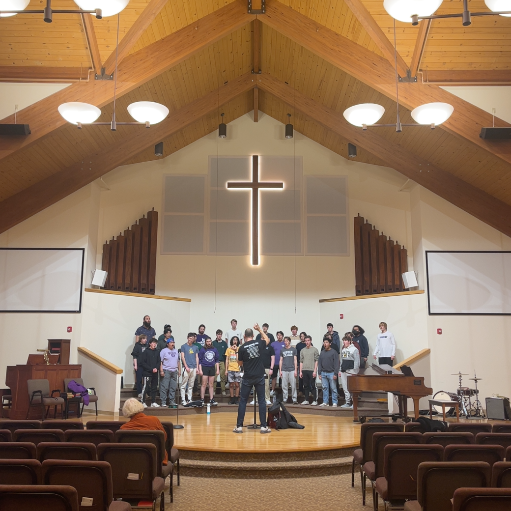 Goshen's college students music choir singing in a church