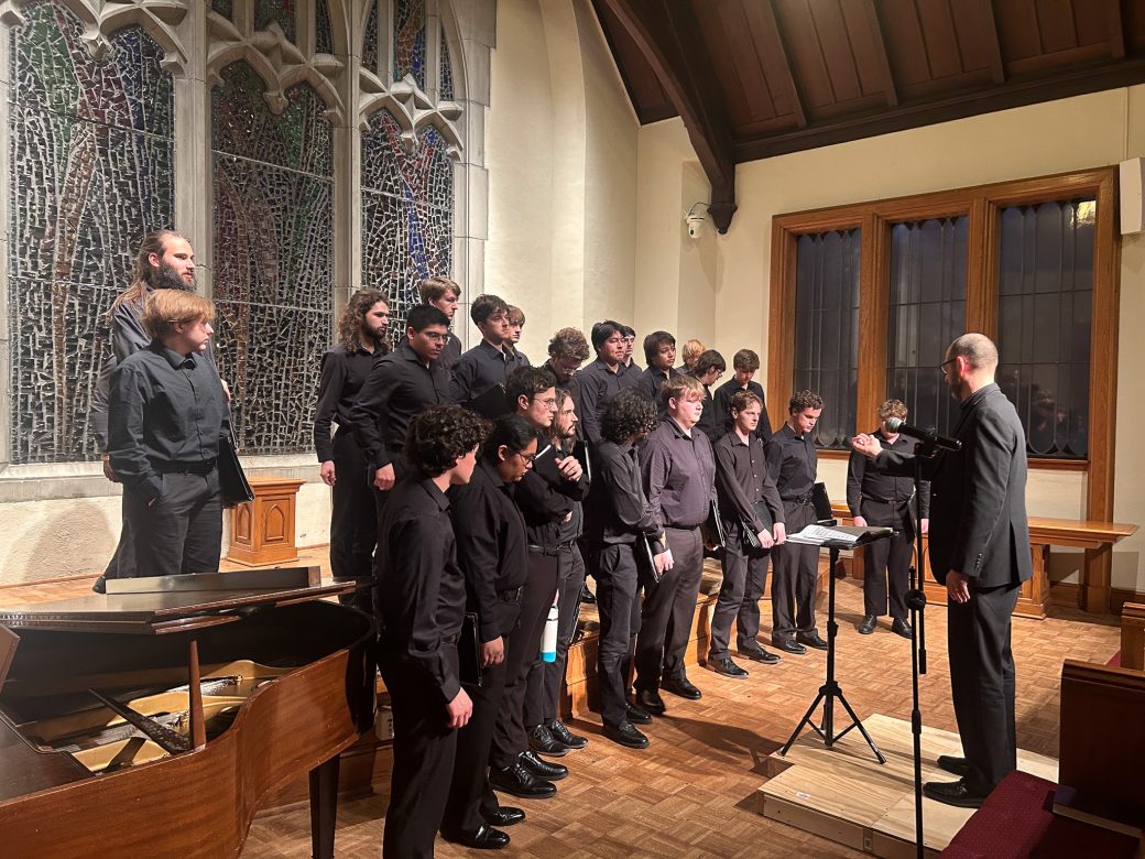 Goshen's college students music choir singing in a church