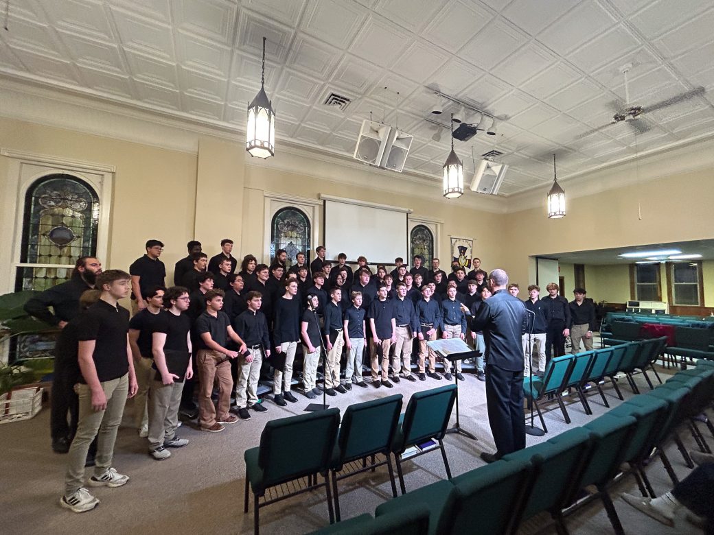 Goshen's college students music choir singing in a church