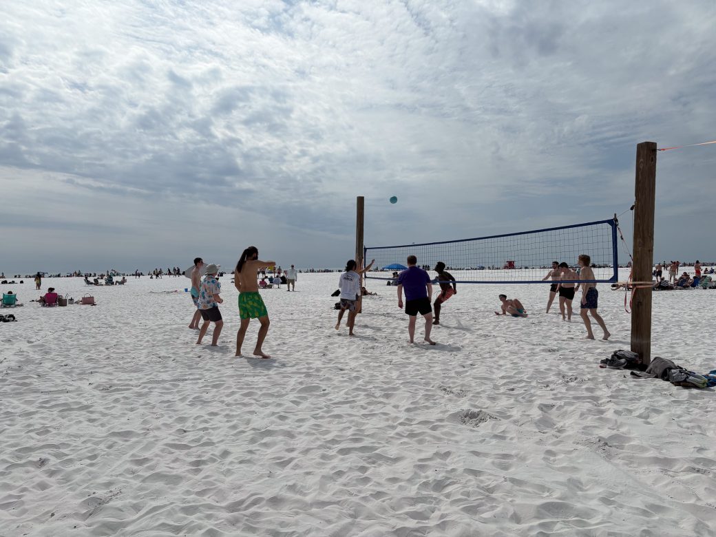 Goshen's college students playing Volleyball at the beach