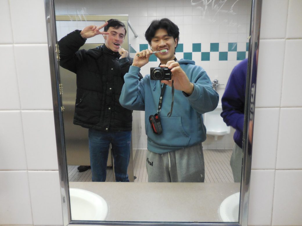 Two students taking a photo at the mirror