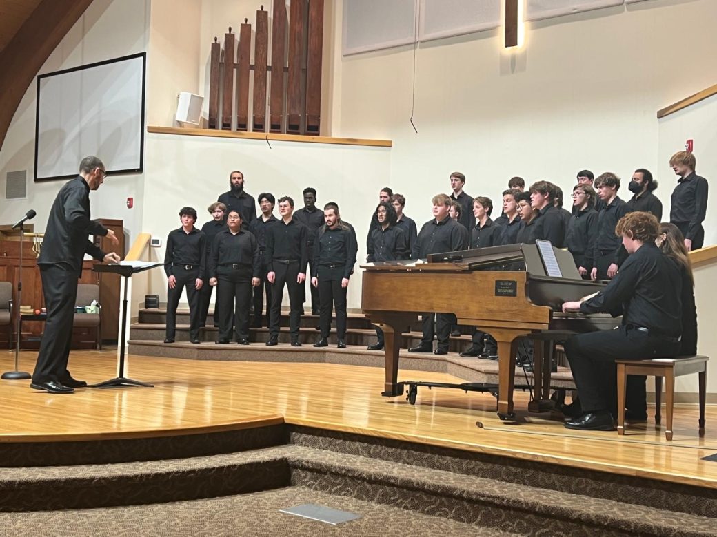 Goshen's college students music choir singing in a church