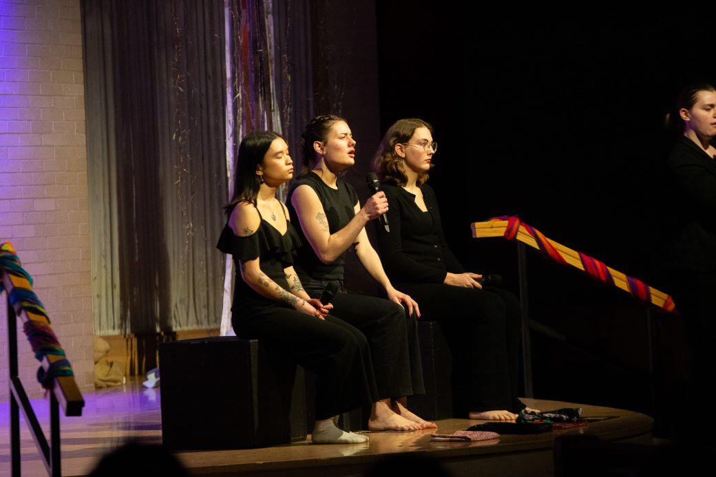 Three presenters of Goshen Monologues 2025 at the stage doing a speech